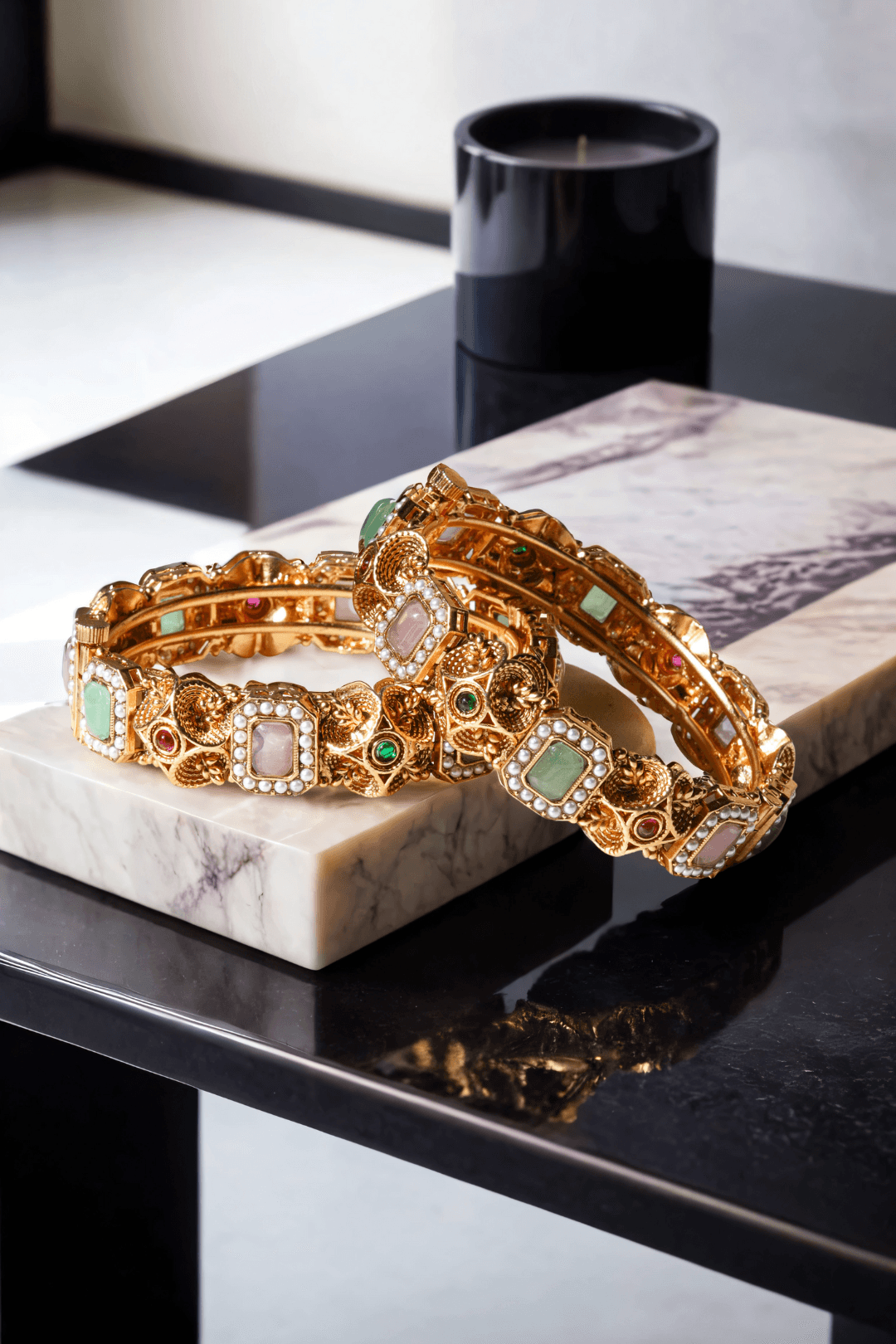 Set of matte gold South Asian bangles with pastel stones and faux pearl detailing from Inaury
