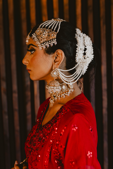 Side profile of bride in Sareena Mirror Choker Set - Zircon & Pearl, styled with matching earrings and headpiece for traditional Desi bridal look.