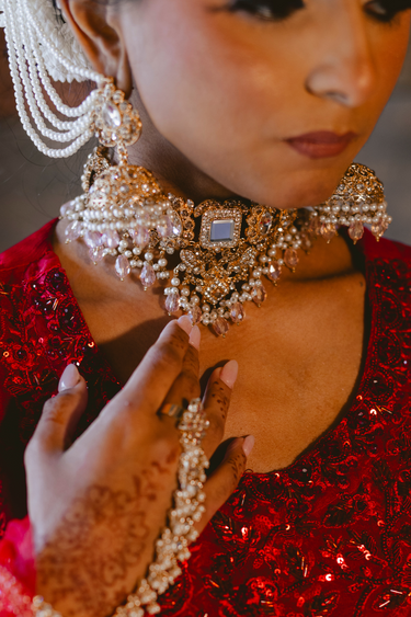 Close-up of Sareena Mirror Choker Set - Zircon & Pearl on bride, showcasing intricate mirror embellishments and pearl detailing for bridal elegance.