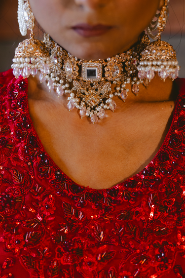 Detailed view of Sareena Mirror Choker Set - Zircon & Pearl highlighting mirror centerpiece and pearl drops, ideal for Desi bridal jewelry sets.