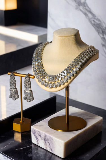 Zaina Double Layered AD Necklace Set in rhodium finish with matching CZ earrings on a marble base. Ideal for luxury jewelry collections.