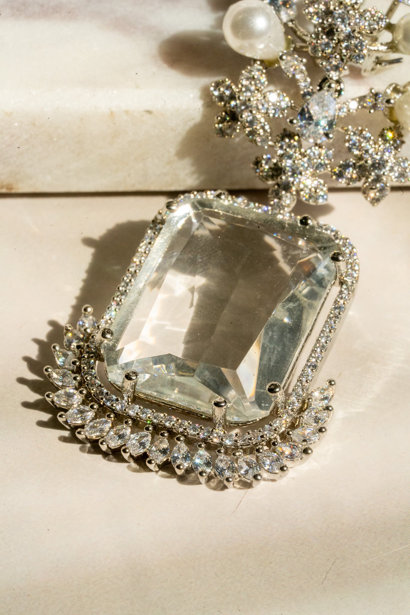 Close-up of crystal white gemstone on Aayat Statement Earrings, highlighting the pavé halo and fine rhodium-plated craftsmanship.