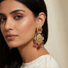 Modern South Asian model wearing Adrita peacock Kundan earrings for a traditional Mehendi celebration.