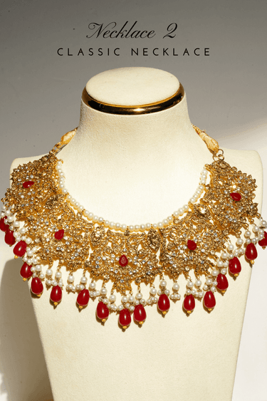 Amreen Gold Plated Red Bridal Set - 5-piece jewelry set with gold plating, white and golden zircon stones, faux pearls, and red beads.