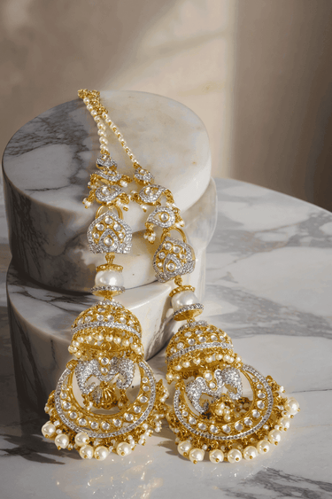 Gold-plated kundan jhumka earrings with sculpted bird motif and pearl danglings – Inaury.com