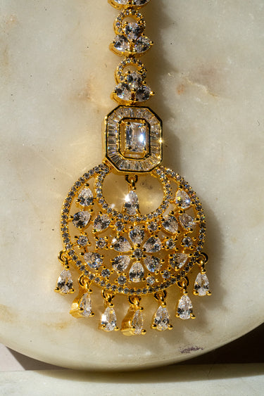 Gold-plated floral maang tikka with American Diamonds in white and pink from Inaury