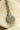 Rhodium-plated floral maang tikka with AD stones in a silver and mint from Inaury