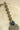Rhodium-plated floral maang tikka with AD stones in a silver and sapphire blue from Inaury