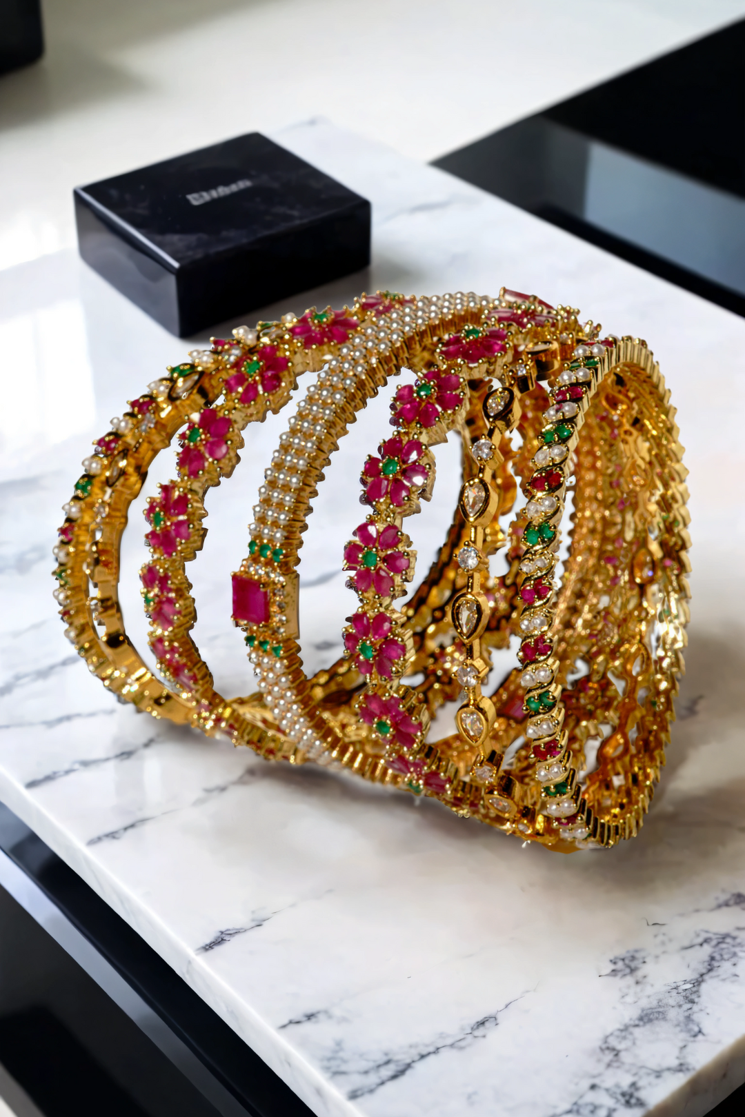 Arika floral bangle set with intricate ruby and emerald designs on gold-plated base. Premium 7-piece jewelry for special occasions.