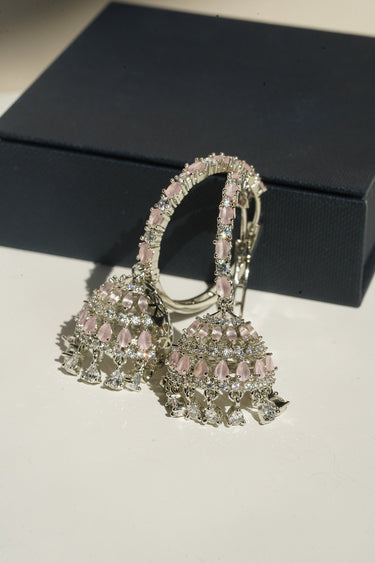 Disha blush pink AD hoop jhumka earrings angled view showing American Diamond teardrop dangles and lattice dome