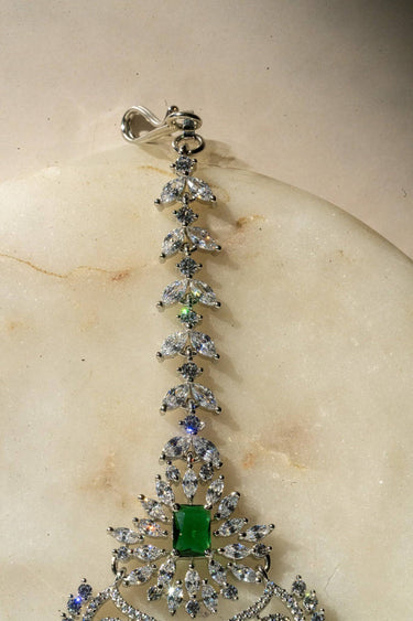 Close-Up of Rhodium-Plated Multicolor AD Maang Tikka with Green and White Stones