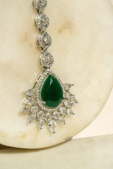 Rhodium-plated maang tikka with matte green teardrop center and white AD stones from Inaury