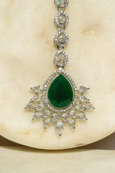 Rhodium-plated maang tikka with matte green teardrop center and white AD stones from Inaury