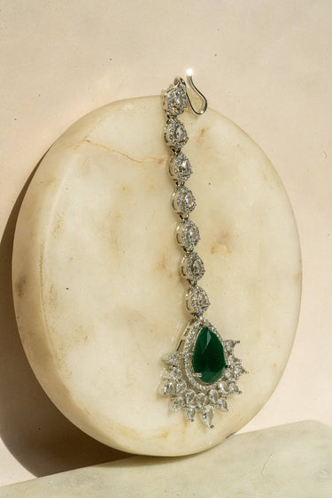 Rhodium-plated maang tikka with matte green teardrop center and white AD stones from Inaury