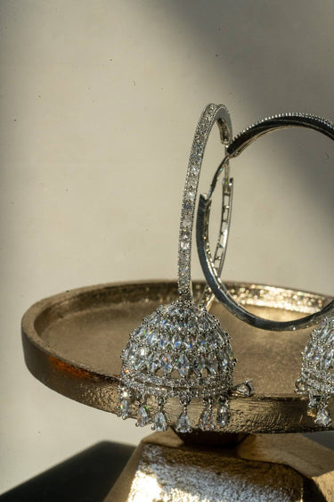 Close-up of Gina Diamante Long Hoop Jhumka Earrings on plate