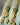 Gold-plated long jhumka earrings with moissanite polki stones, pearls, and green enamel - Indian earrings from Inaury