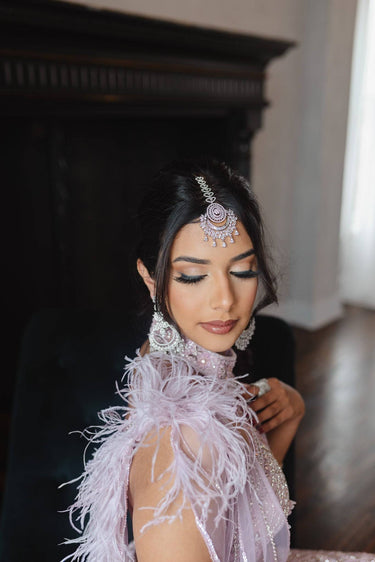 Iliyana Maang Tikka in rhodium finish with CZ stones, featuring a floral crescent design. Ideal for bridal and festive hair styling by Inaury.