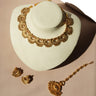 Ishani antique gold crescent necklace on a cream bust with matching earrings and maang tikka
