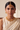 Front portrait of a model wearing the Ishani antique gold crescent choker, earrings and maang tikka with an ivory sari
