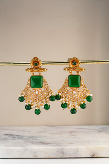 A front e-commerce catalog display showcasing the monochrome emerald green variant of the Kavya gold-plated statement chandbali earrings.