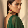 Side profile portrait of a model showcasing the length and detailing of the gold-plated Kavya ruby and emerald chandbali earrings.