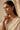 Side profile view of a model styling the delicate single-strand Kiara heart Kundan necklace over a white embroidered bridal saree.
