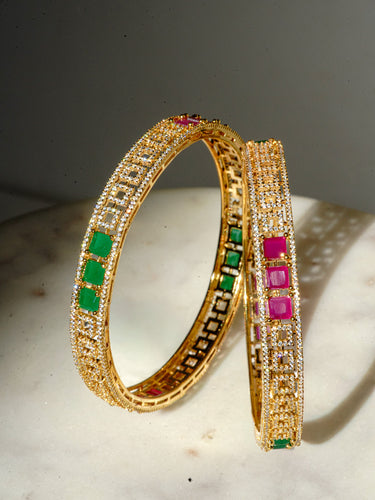 A symmetrical vertical profile image of the gold plated Kyra AD stone bangles highlighting how the premium stones catch and reflect natural light.