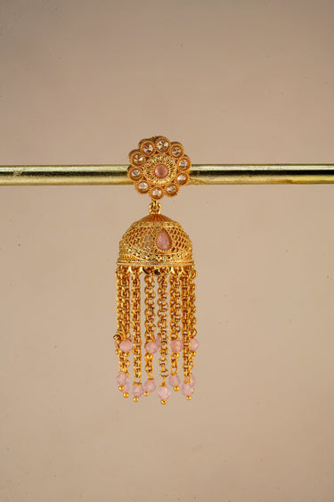 A close up studio product shot of a single Lara handcrafted gold jhumka earring highlighting the floral stud and long cascading bead chains.