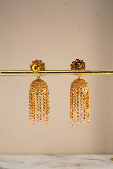 A clean studio view of the reverse side of the Lara gold jhumka earrings on a display bar showing the push back closure and finish quality.