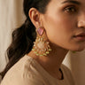 A macro profile shot of a model wearing the blush pink and mint green Mira peacock statement earrings to display the scale and fit against the jawline.