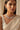 A close-up front view of a model showcasing the intricate emerald and baguette crystal pattern of the rhodium-plated Shanaya choker necklace.