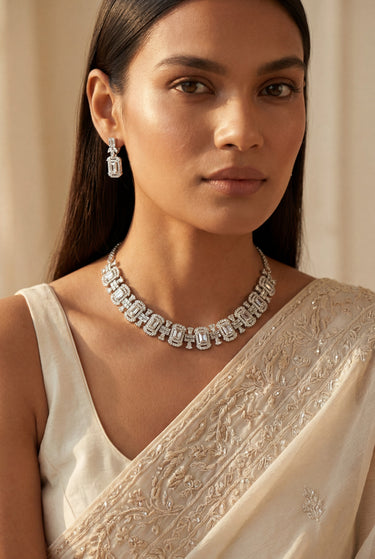 A close-up front view of a model showcasing the intricate emerald and baguette crystal pattern of the rhodium-plated Shanaya choker necklace.