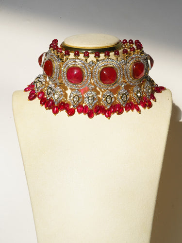 An angled product display layout of the gold-plated Sweta choker showing the textured pearl drop fringe and matching 1.5-inch earrings.