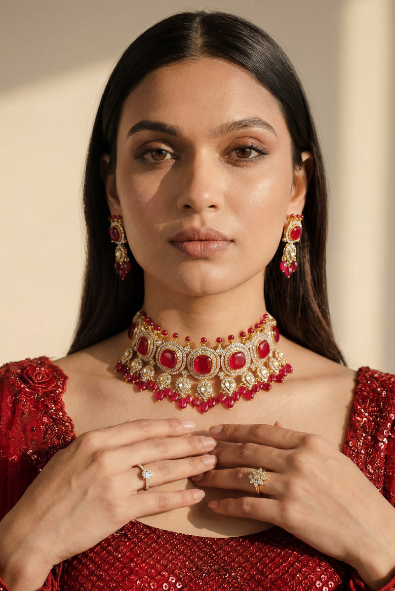 A closer neckline view on a model showing the collarbone contouring drape of the Sweta antique gold-plated red choker set.