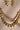 Angled view of the layered Kundan pearl necklace showing linked round stones and dangling pearl clusters.