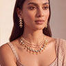 Model wearing a layered Kundan pearl choker necklace with matching gold-plated drop earrings, Yasmin set.