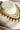 Reverse view of the layered Kundan pearl necklace showing pierced gold-plated stone settings and pearl drops.
