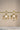 A crisp front studio view of the pair of Zoe mehndi gold drop earrings showcasing the symmetrical layout of crystals on a display bar.