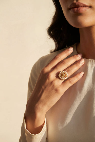 South Asian woman wearing Asal gold plated pearl dome ring with floral AD stone design Inaury contemporary desi jewelry