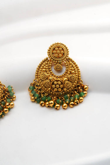 Closeup of Inaury Gurleen Gold Chandbali Earring — detail of antique gold granulation texture, flower rosette center medallion and emerald bead with ghungroo drop fringe