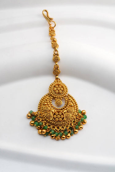 Inaury Gurleen Gold Maang Tikka — front flat lay showing full chandbali pendant with gold granulation rosette, crescent arch and emerald bead fringe on hook chain