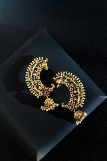 Inaury Maharani Ear Cuffs with Jhumka Ruby Emerald on dark surface — handcrafted South Asian ear cuff jewelry with vibrant gemstone detailing and pearl accents