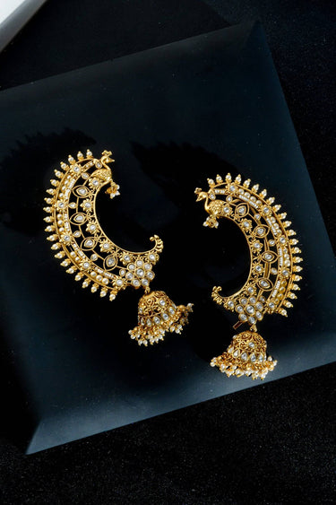 Inaury Maharani Ear Cuffs with Jhumka Ruby Emerald flatlay — gold-plated South Asian statement ear cuffs with ruby, emerald, and pearl details on dark background