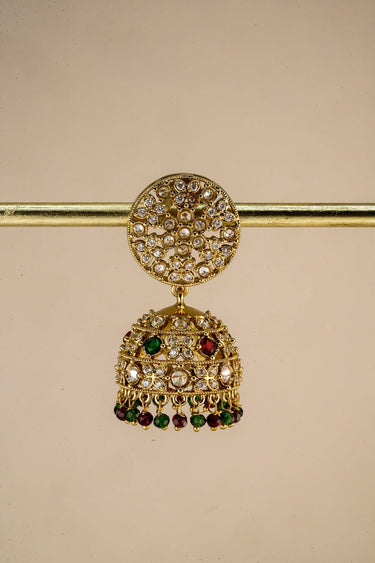 Inaury Nakshi Round Emerald jhumka earrings — gold disc top with deep green AD accents and emerald crystal drops on model