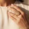 Yasna gold plated AD statement ring closeup on hand showing oversized pavé dome design Inaury