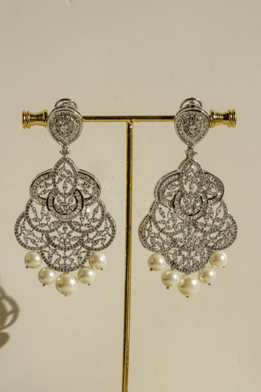 Irene Radiant Pearl Drop Earrings, rhodium-plated with intricate filigree design, pavé white stones, and pearl drops, 3.4 inches long - Indian jewelry for festive and wedding occasions.