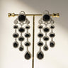 Jennie AD Chandelier Earrings in rhodium-plated silver, available in six colors: silver & emerald green, silver & turquoise, silver & sapphire blue, silver & maroon, silver & purple, silver & black, featuring asymmetrical design and AD stones.