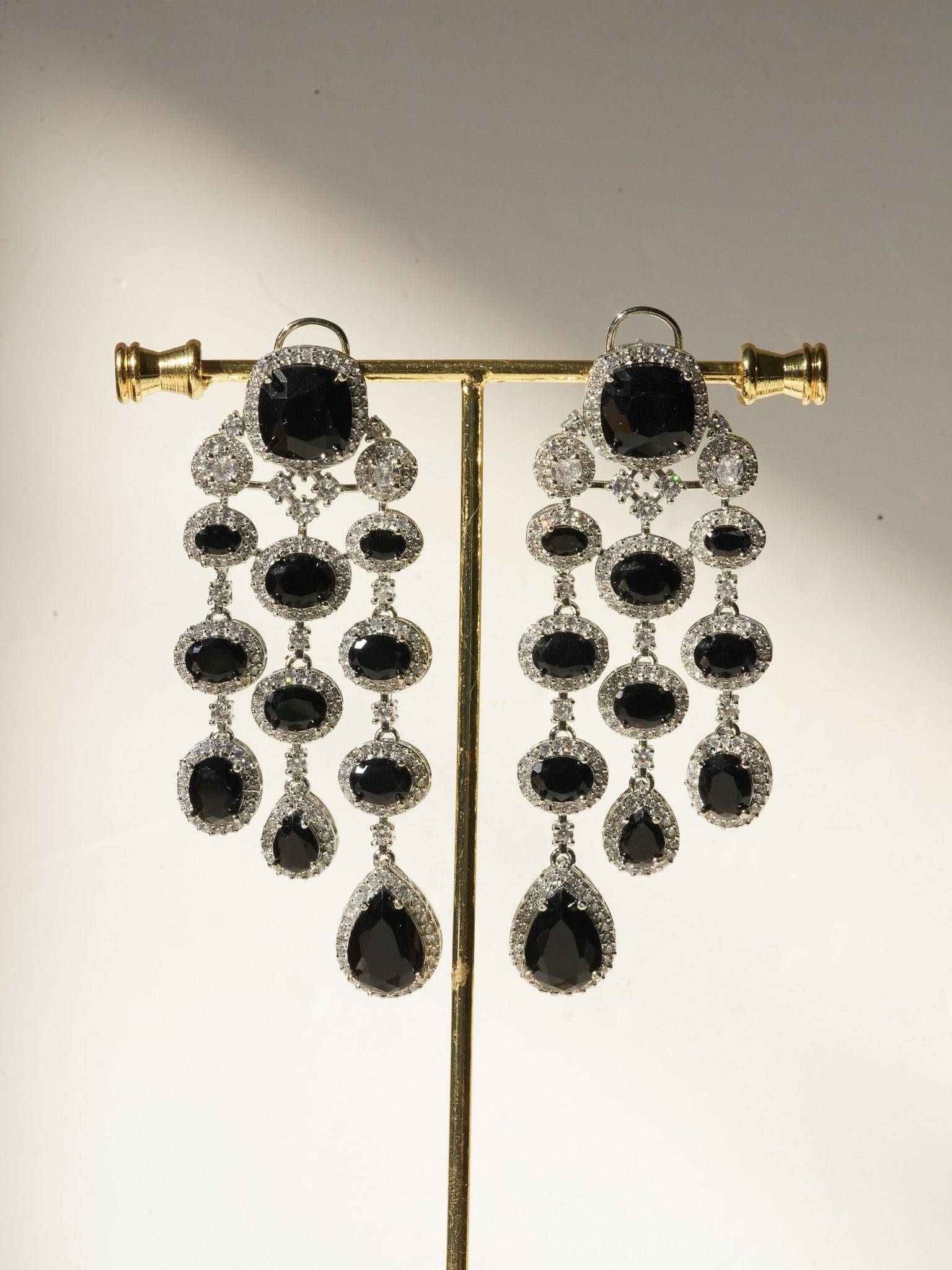 Jennie AD Chandelier Earrings in rhodium-plated silver, available in six colors: silver & emerald green, silver & turquoise, silver & sapphire blue, silver & maroon, silver & purple, silver & black, featuring asymmetrical design and AD stones.