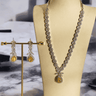 Lina Long Diamante Accent AD Necklace Set - Rhodium-plated with white AD stones, featuring intricate patterns and pendant-like centerpiece, available in silver & sapphire blue, silver & purple, and silver & citrine yellow, with matching dangling earrings.