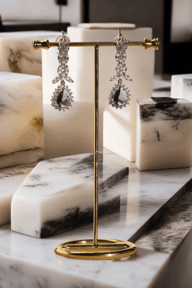 Lina Long Diamante Accent AD Necklace Set - Rhodium-plated with white AD stones, featuring intricate patterns and pendant-like centerpiece, available in silver & sapphire blue, silver & purple, and silver & citrine yellow, with matching dangling earrings.